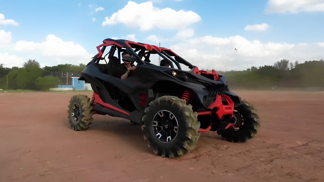 Red and black Ashva 4x4 utility vehicle navigating off road, showcasing its power and adaptability in off-road environments.