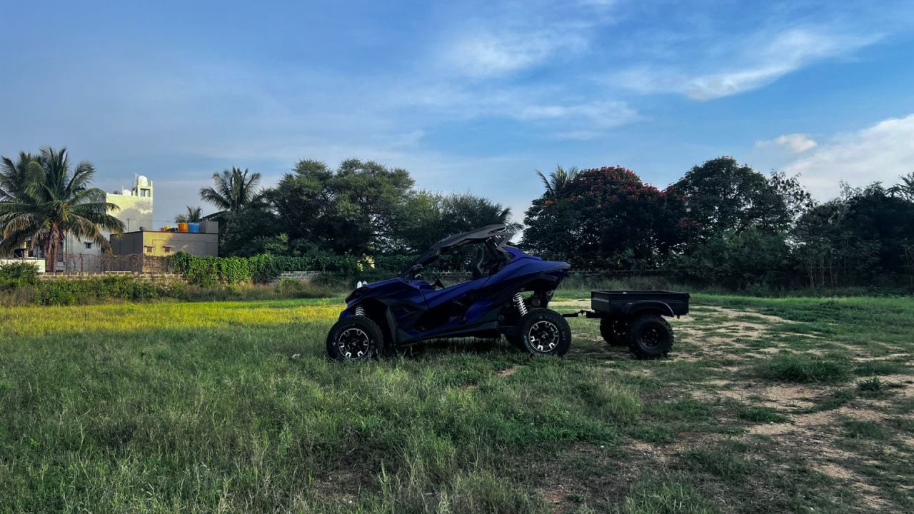 Red and black colour Ashva 4x4 parked on a rugged rock surface, showcasing its off-road capabilities.
